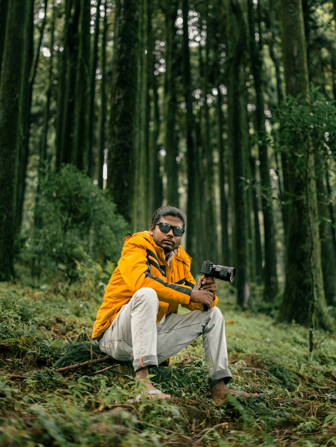 Photographer crouching to take a photo outdoors