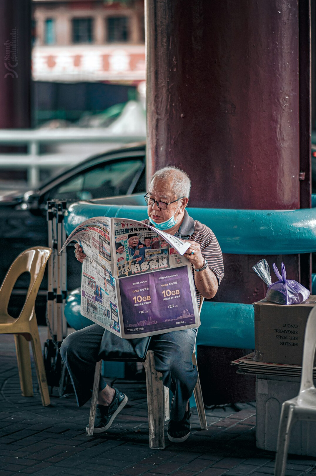 elderly man reading newspaper