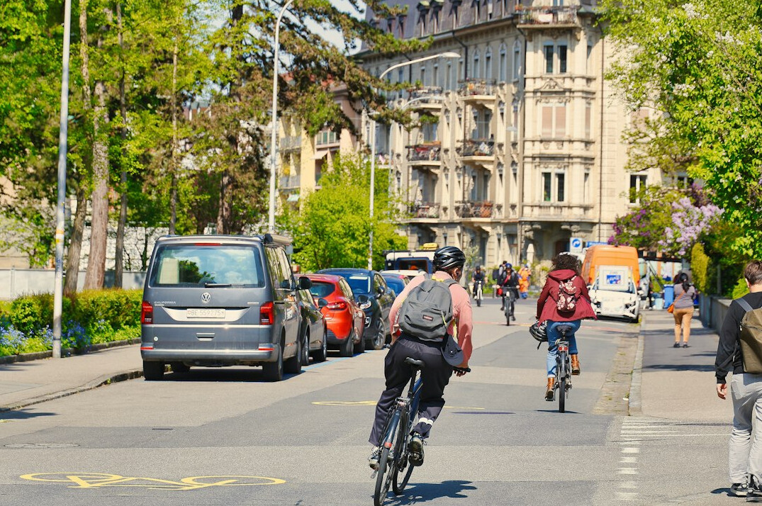 Cyclists riding through a European city street