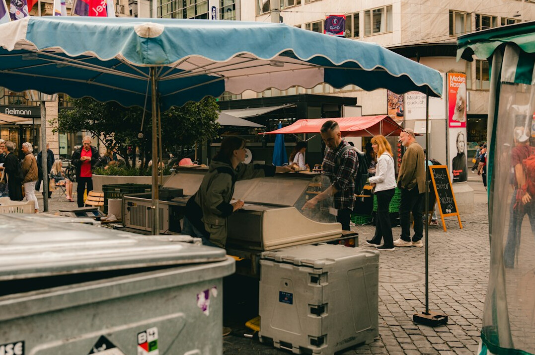 Vendor and customer at a local outdoor food market stall