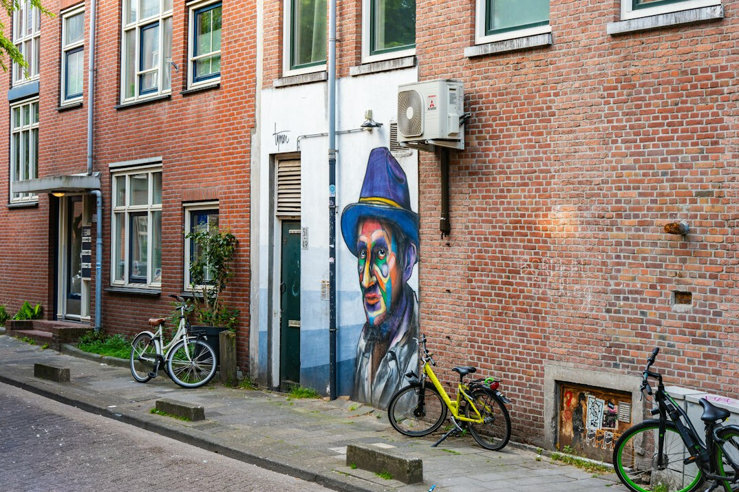 Bicycle leaning against a colorful painted wall