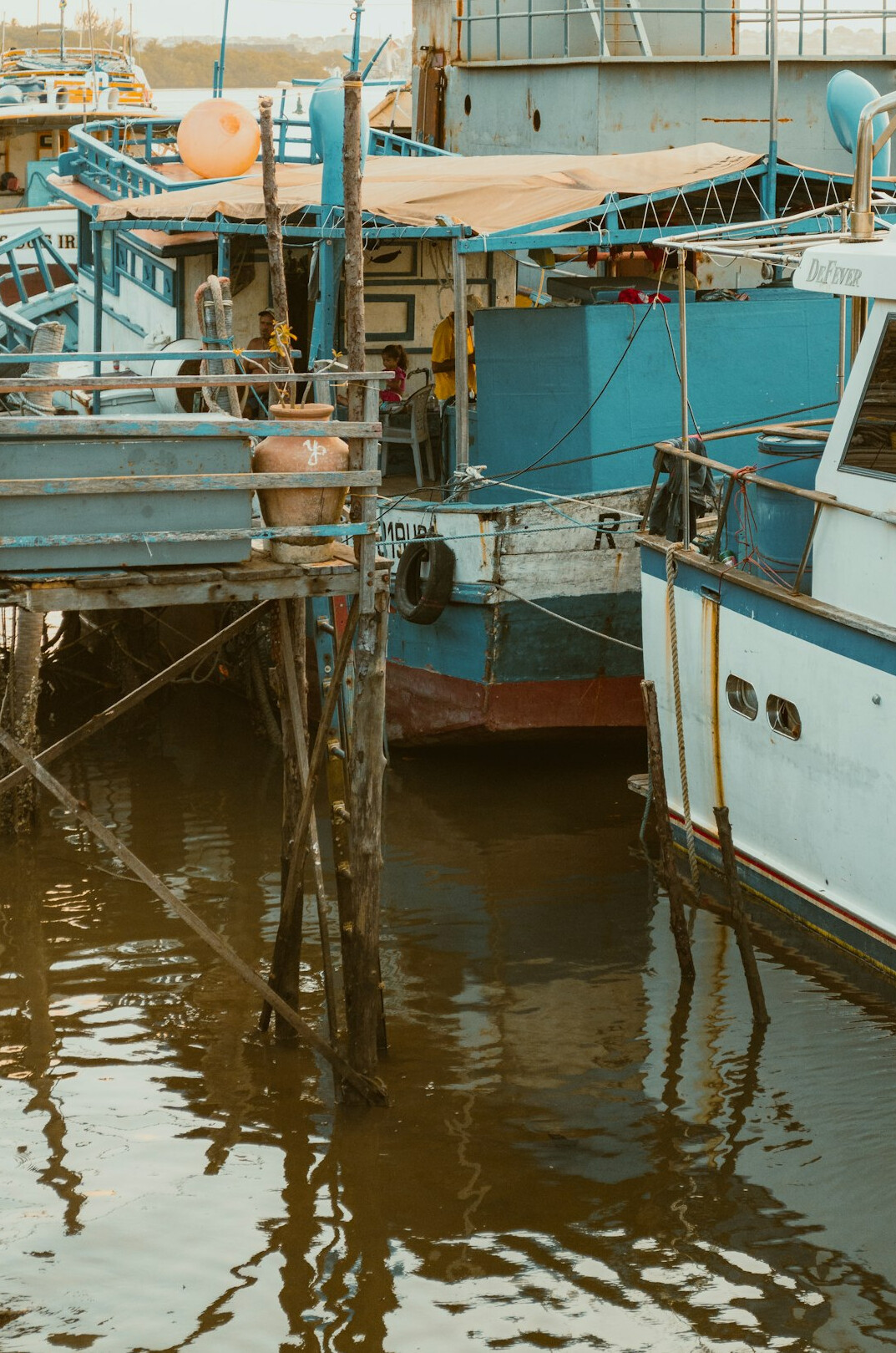 Traditional wooden fishing boats docked in a small harbor